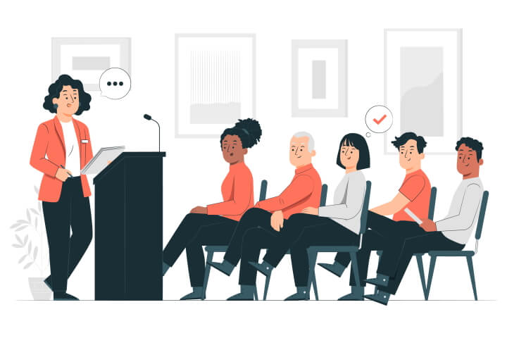 An abstract image depicting a woman giving a public speech to an audience