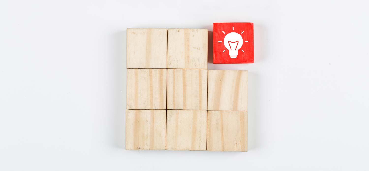 Wooden blocks with lightbulb painted on top right block