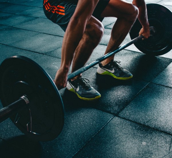 A photo of a person about to lift a heavy weight at a gym
