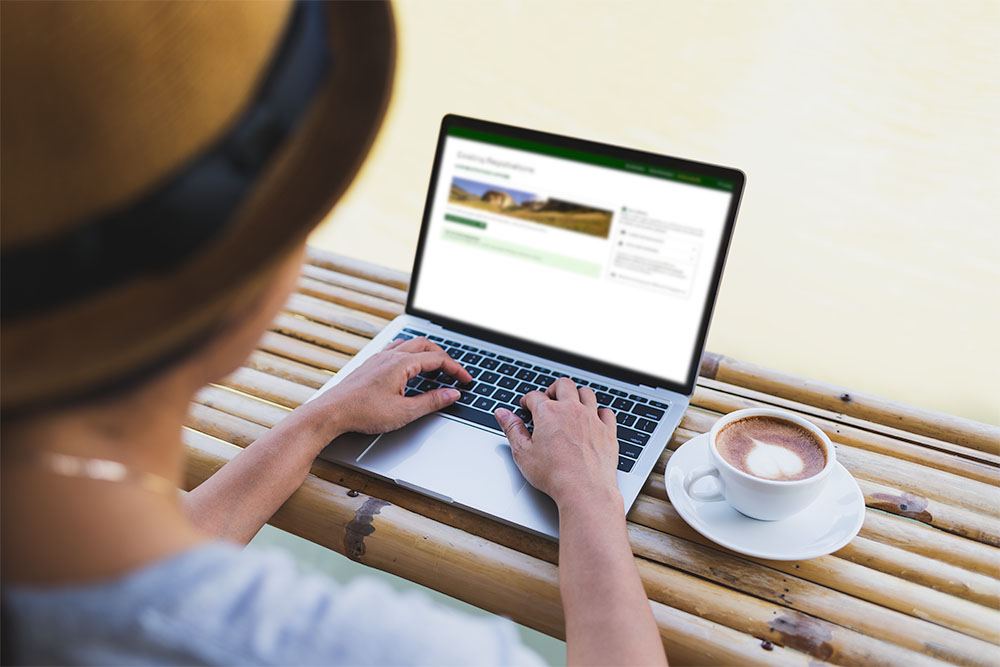 Client using RoomSeeker pre-arrival portal web app by KRS on laptop
